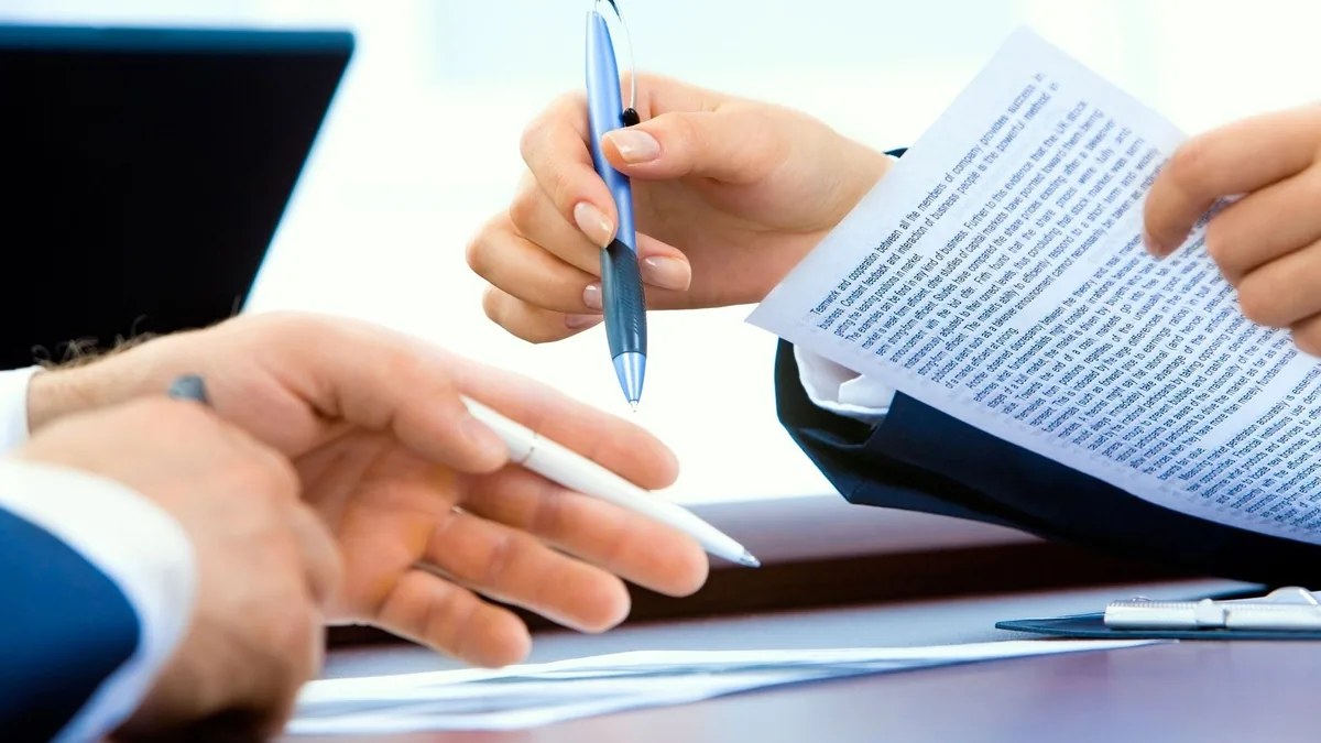 Borrower and financial adviser reviewing a loan settlement agreement